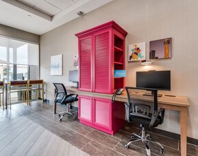Business center with computers, printer and ergonomic chair at Home2 Suites By Hilton Dallas Medical District Lovefield.