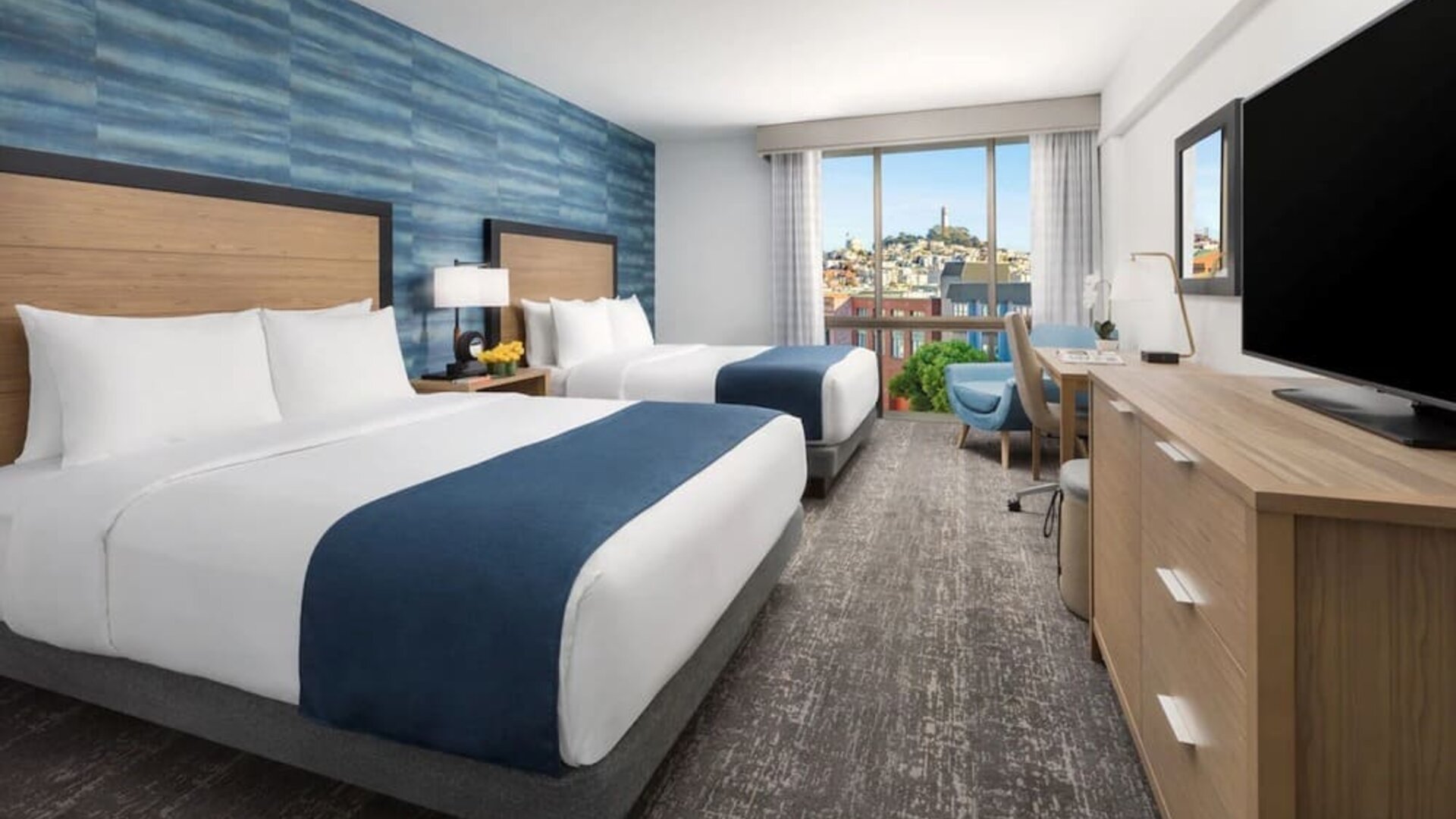 Day use twin room with work desk and floor to ceiling window at Hotel Caza.