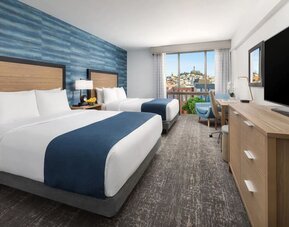 Day use twin room with work desk and floor to ceiling window at Hotel Caza.