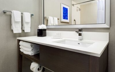 Private guest bathroom with shower and free toiletries at Courtyard Boston Cambridge.
