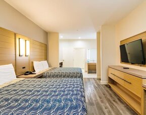 Day use twin room with private bathroom and workspace at Palace Inn Blue IAH East.