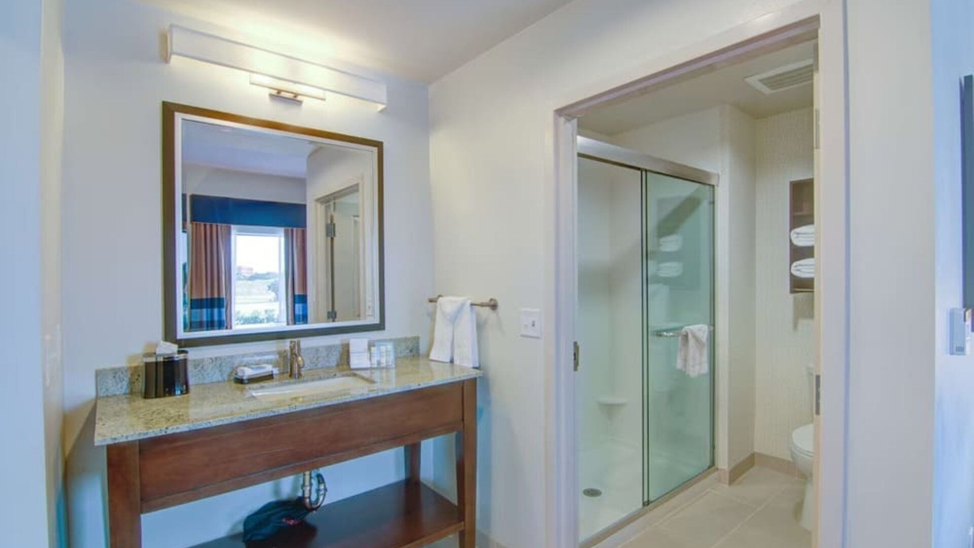 Private guest bathroom with shower and free toiletries at Hampton Inn & Suites Trophy Club - Fort Worth North, TX.