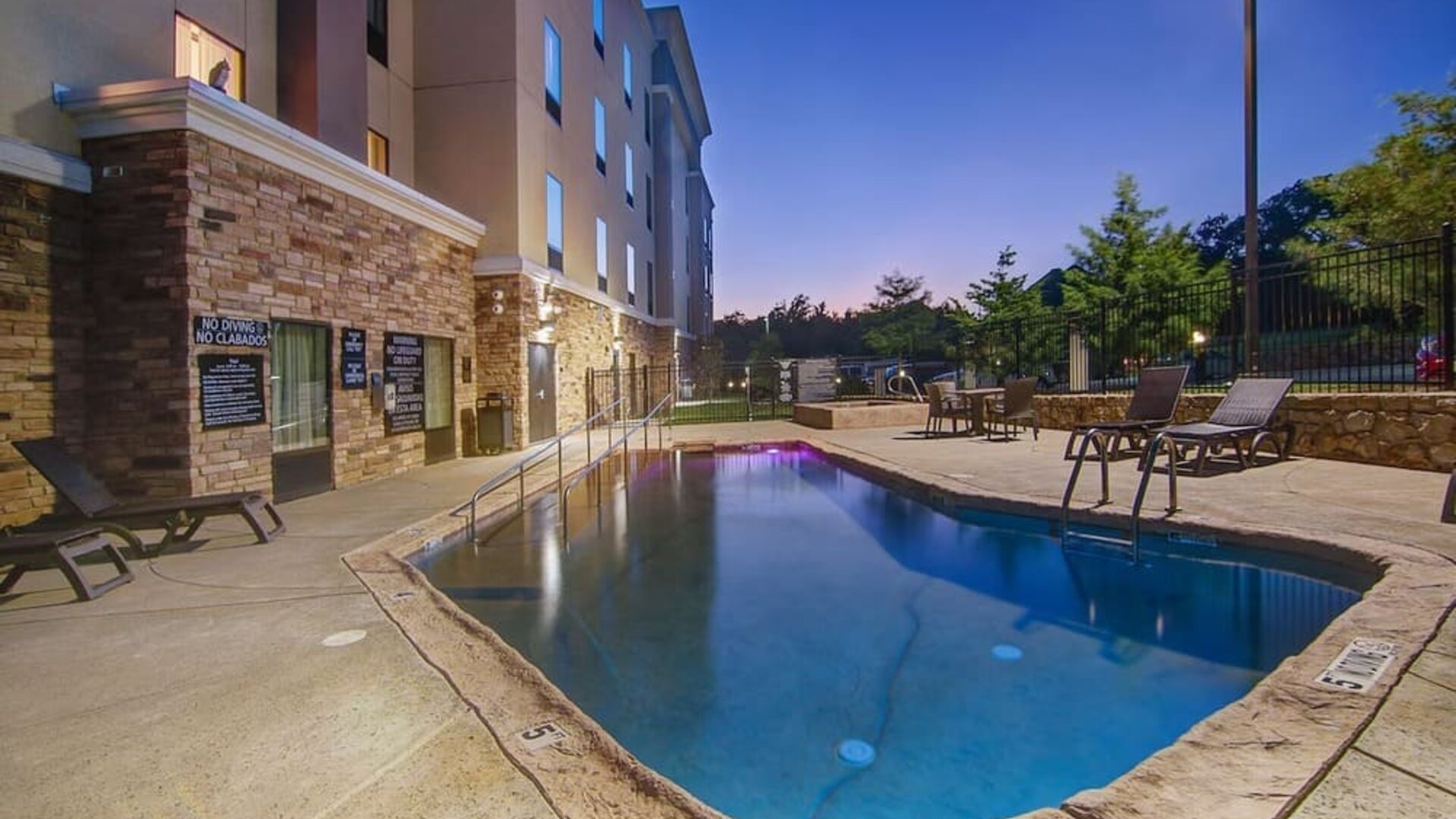 Outdoor pool with lounge chairs at Hampton Inn & Suites Trophy Club - Fort Worth North, TX.