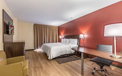 Spacious delux king bedroom with work desk at Red Roof PLUS+ & Suites Houston - IAH Airport SW.