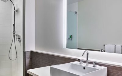 Private guest bathroom with shower at Element Miami International Airport.