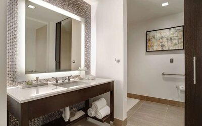 Private guest bathroom with free toiletries at Hilton Dallas/ Plano Granite Park.