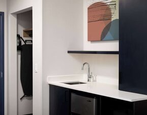 Kitchen and mini-fridge at Spark By Hilton Guelph.