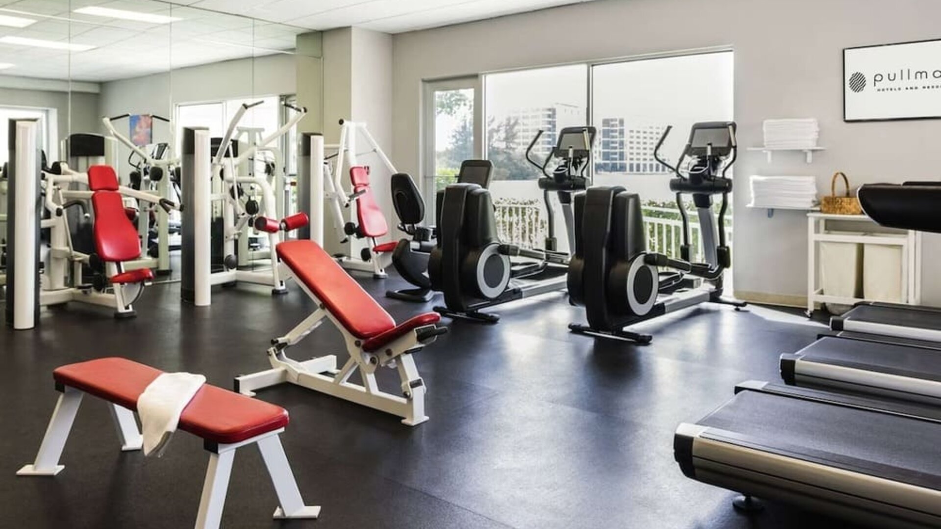 Fitness center with natural light at Pullman Miami Airport.
