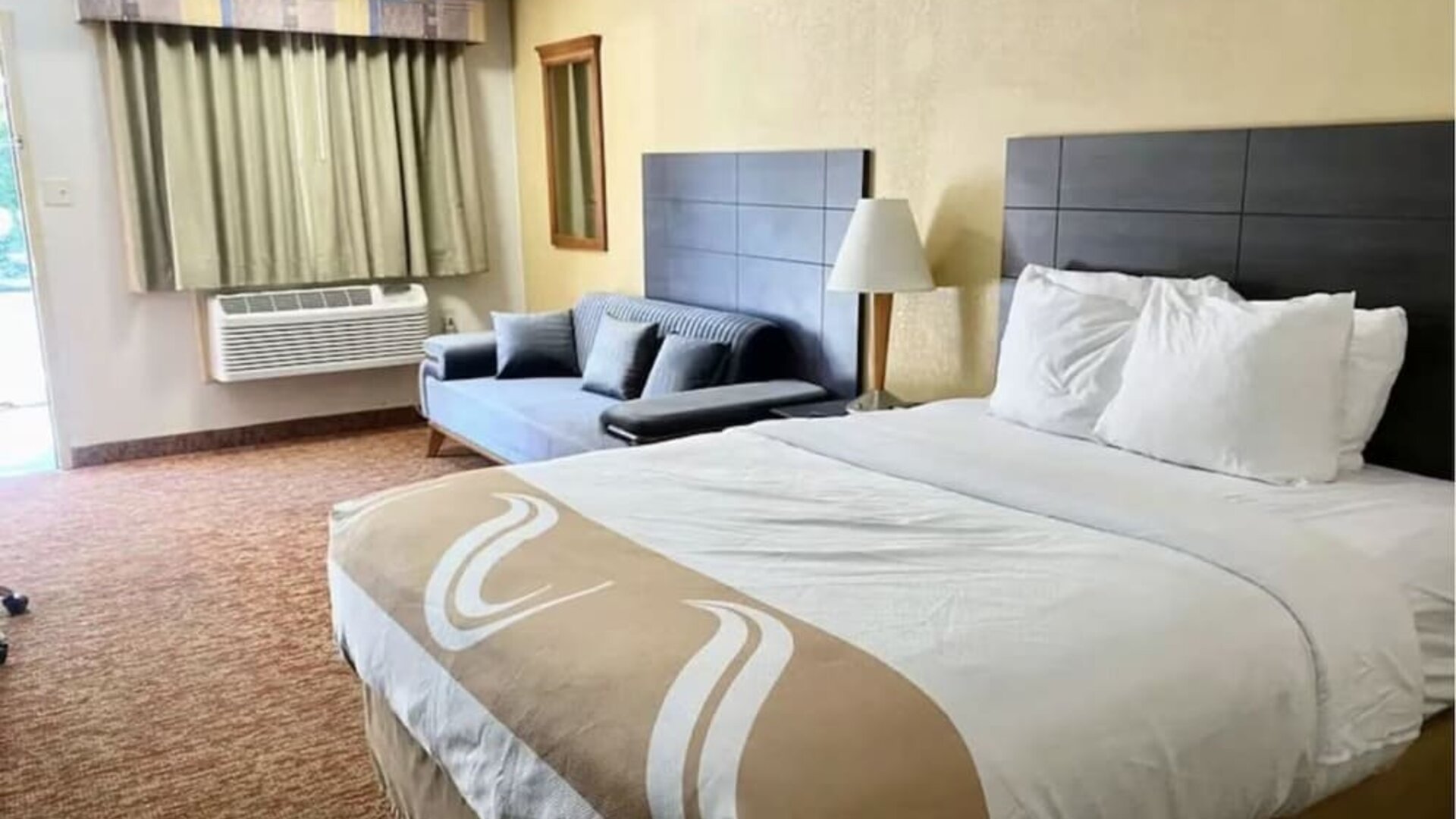 King bed with AC at Hibiscus Inn & Suites.