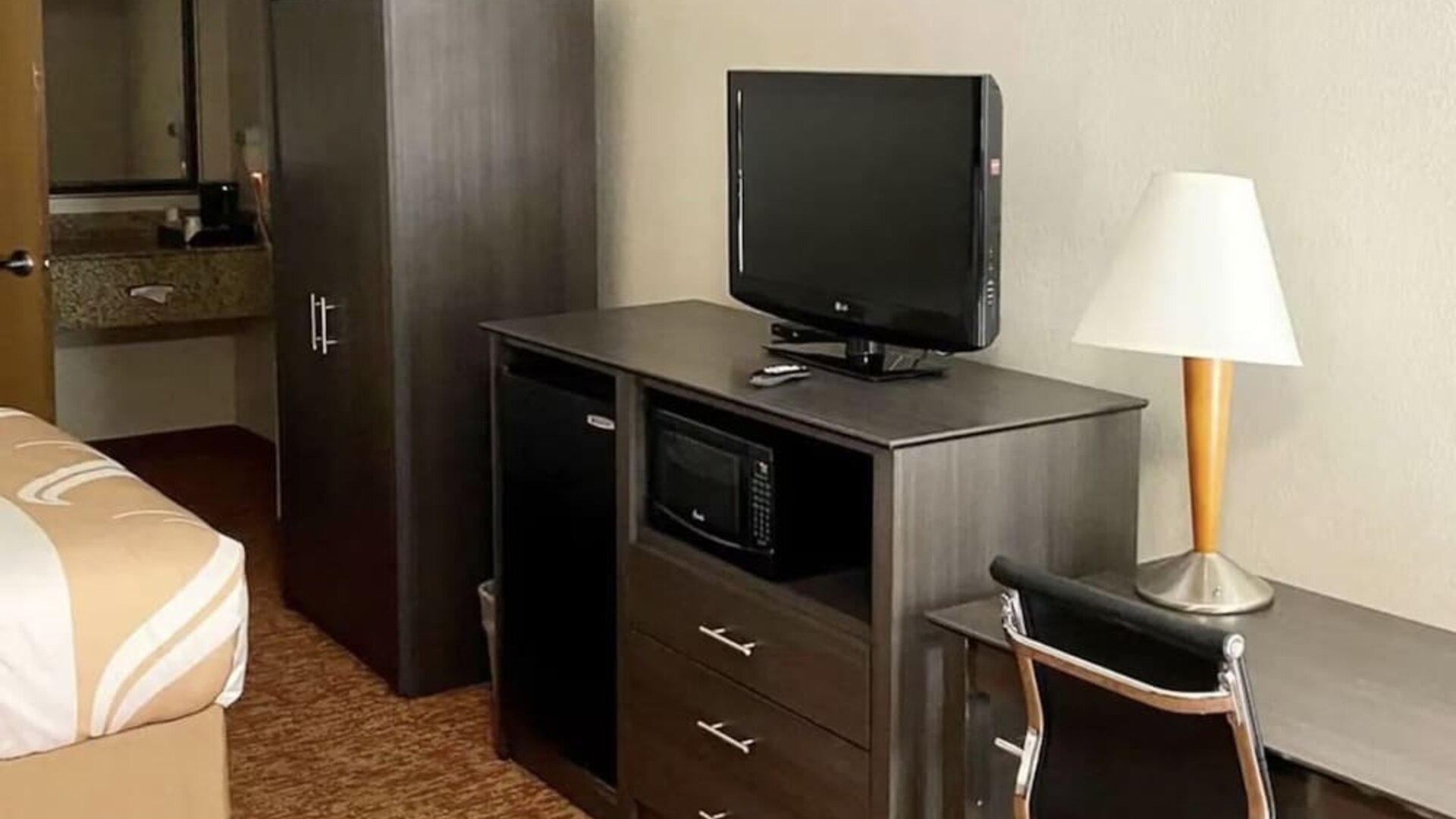 TV and work desk at Hibiscus Inn & Suites.