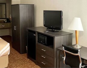 TV and work desk at Hibiscus Inn & Suites.