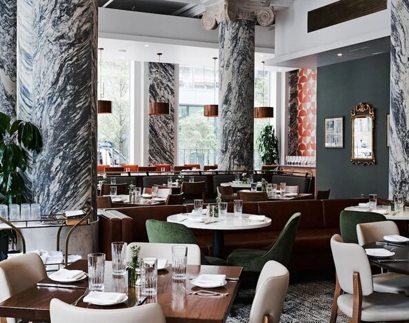 Dining area with natural light perfect for coworking at The Candler Hotel Atlanta, Curio Collection By Hilton.