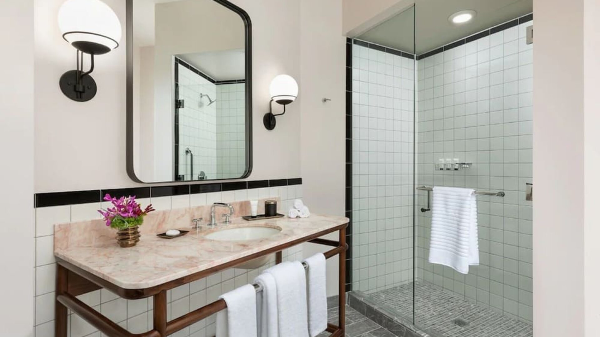Private guest bathroom with shower at The Candler Hotel Atlanta, Curio Collection By Hilton.