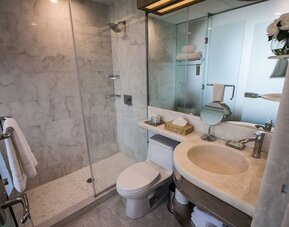 Private guest bathroom with shower and free toiletries at Wyndham Garden Brooklyn Sunset Park.