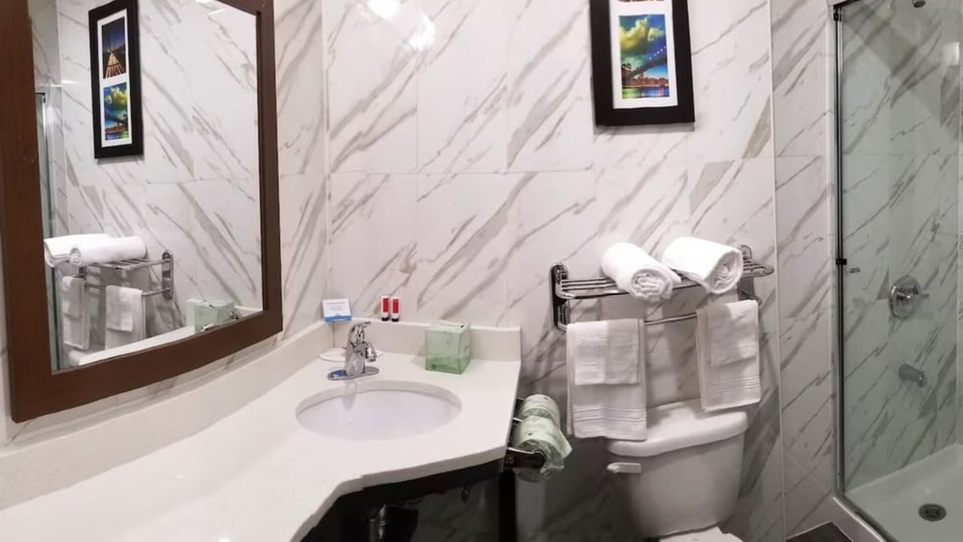 Private guest bathroom with shower and free toiletries at Days Inn By Wyndham Brooklyn Marine Park.