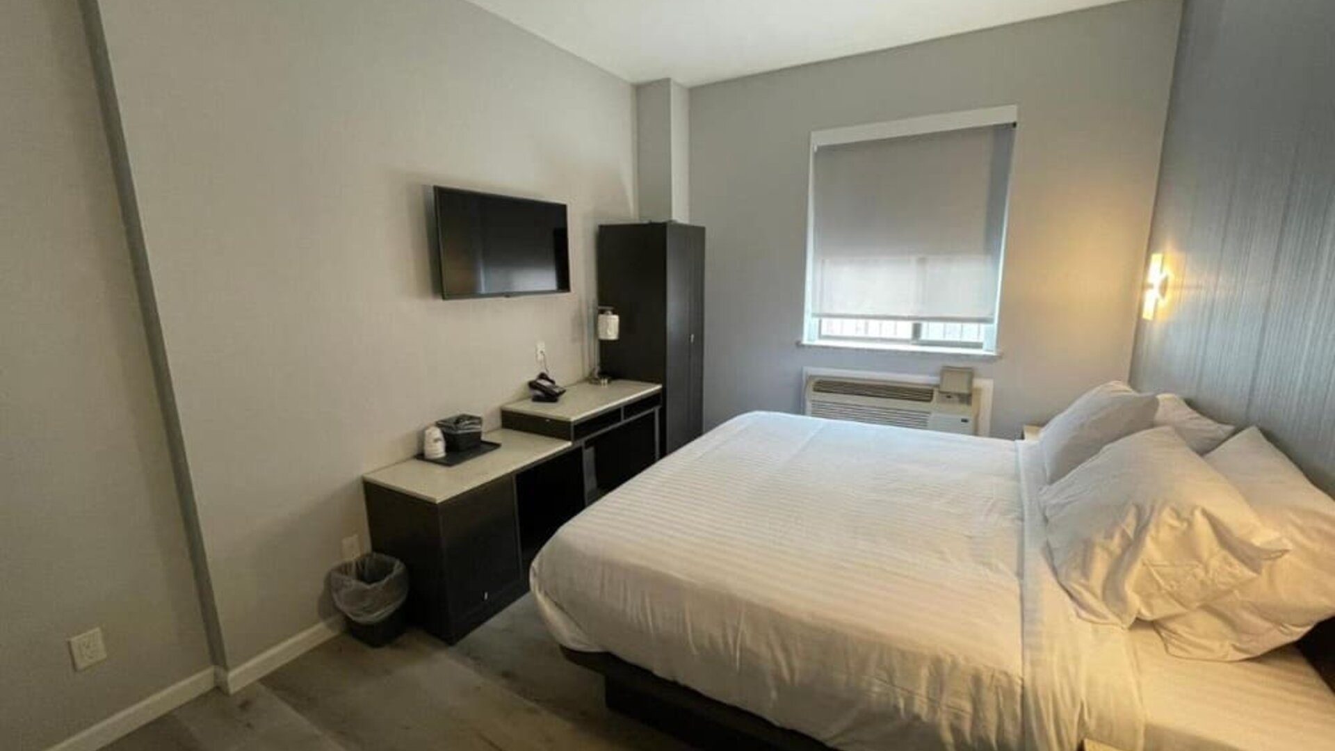 Standard room with king bed and workspace at King Hotel Brooklyn.