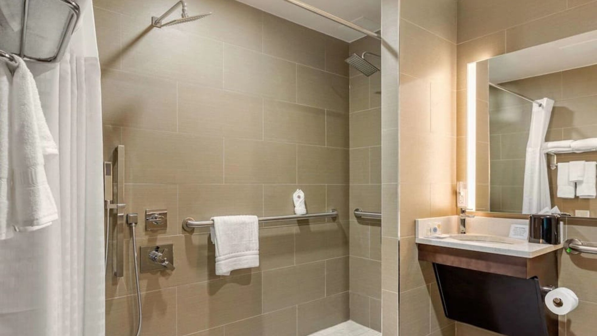Private guest bathroom with combined shower and tub at Comfort Inn Prospect Park-Brooklyn.