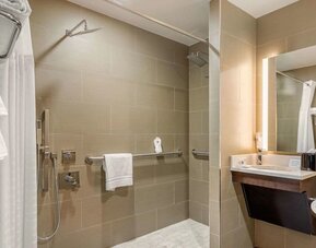 Private guest bathroom with combined shower and tub at Comfort Inn Prospect Park-Brooklyn.