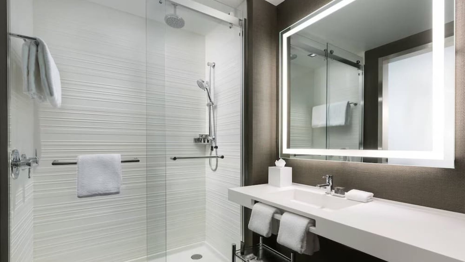 Private guest bathroom with shower and free toiletries at AC Hotel New York Times Square.