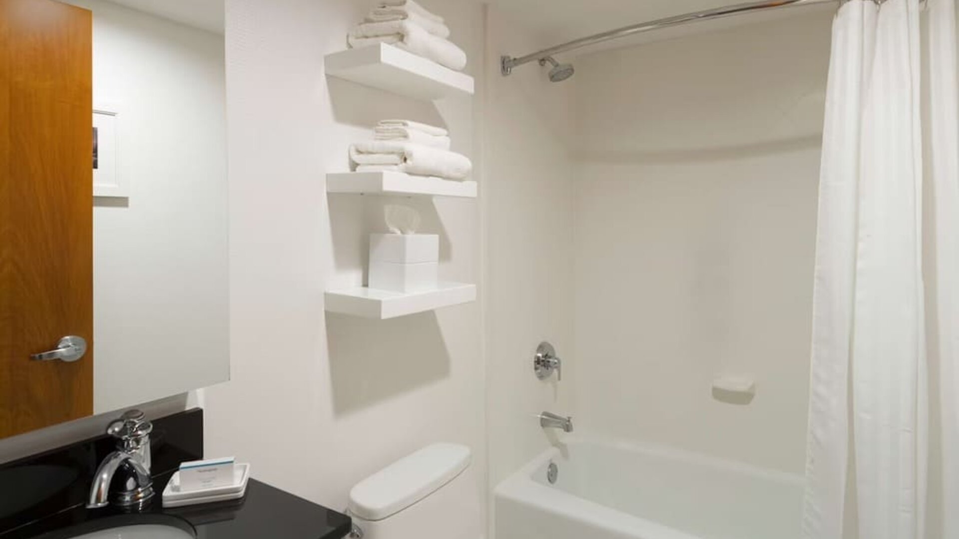 Private guest bathroom with combined shower and tub at Hampton Inn Manhattan - Madison Square Garden.
