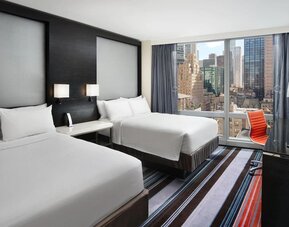 Day use twin room with work desk and floor to ceiling window at Courtyard By Marriott New York Manhattan/Central Park.