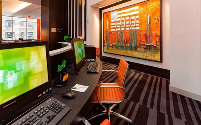 Business center with computers, printer and ergonomic chairs at Courtyard By Marriott New York Manhattan/Central Park.