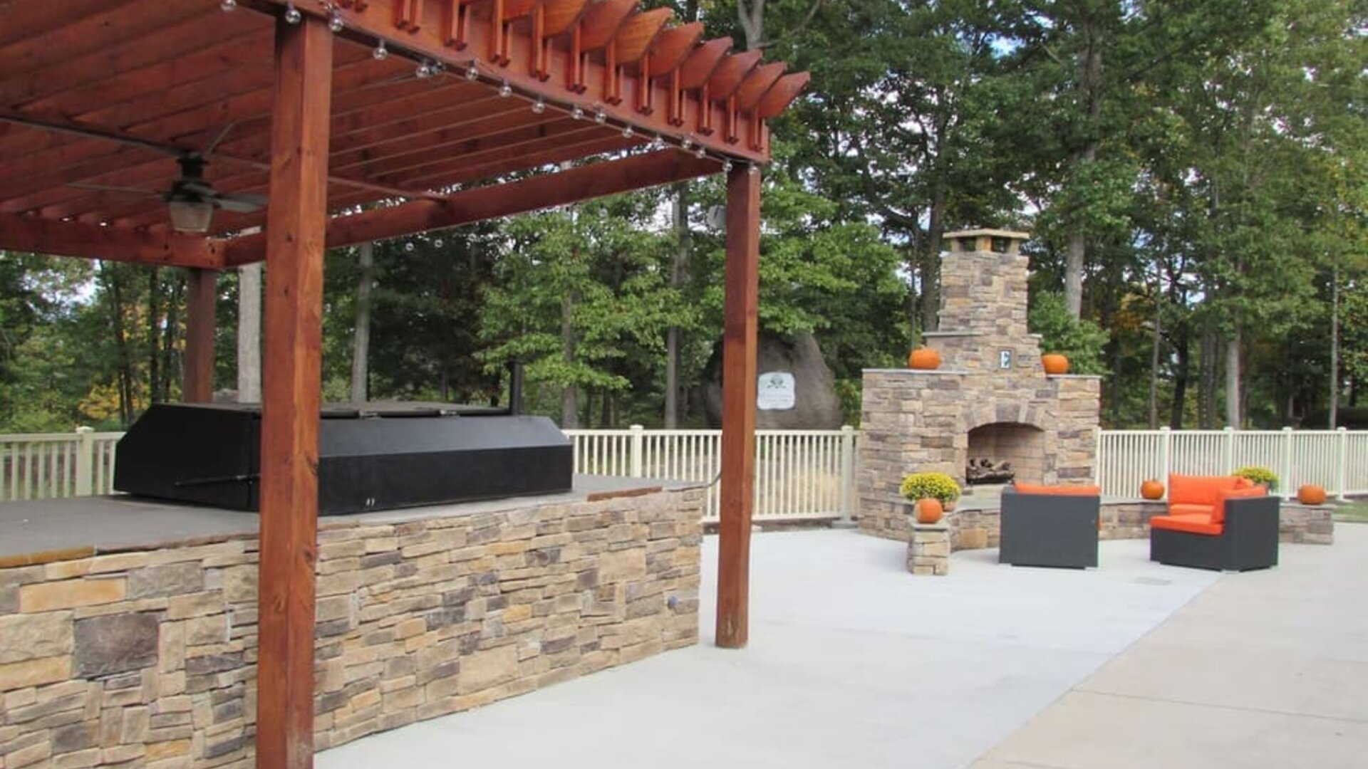 Outdoor furniture and grill area at Embassy Suites By Hilton Charlotte-Concord-Golf Resort & Spa.