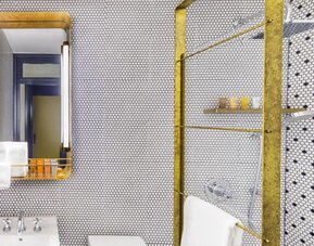 Private guest bathroom with shower and free toiletries at Hotel Shocard NYC.