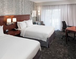 Day use twin room with large windows, work desk and private bathroom at Courtyard Miami Dolphin Mall.