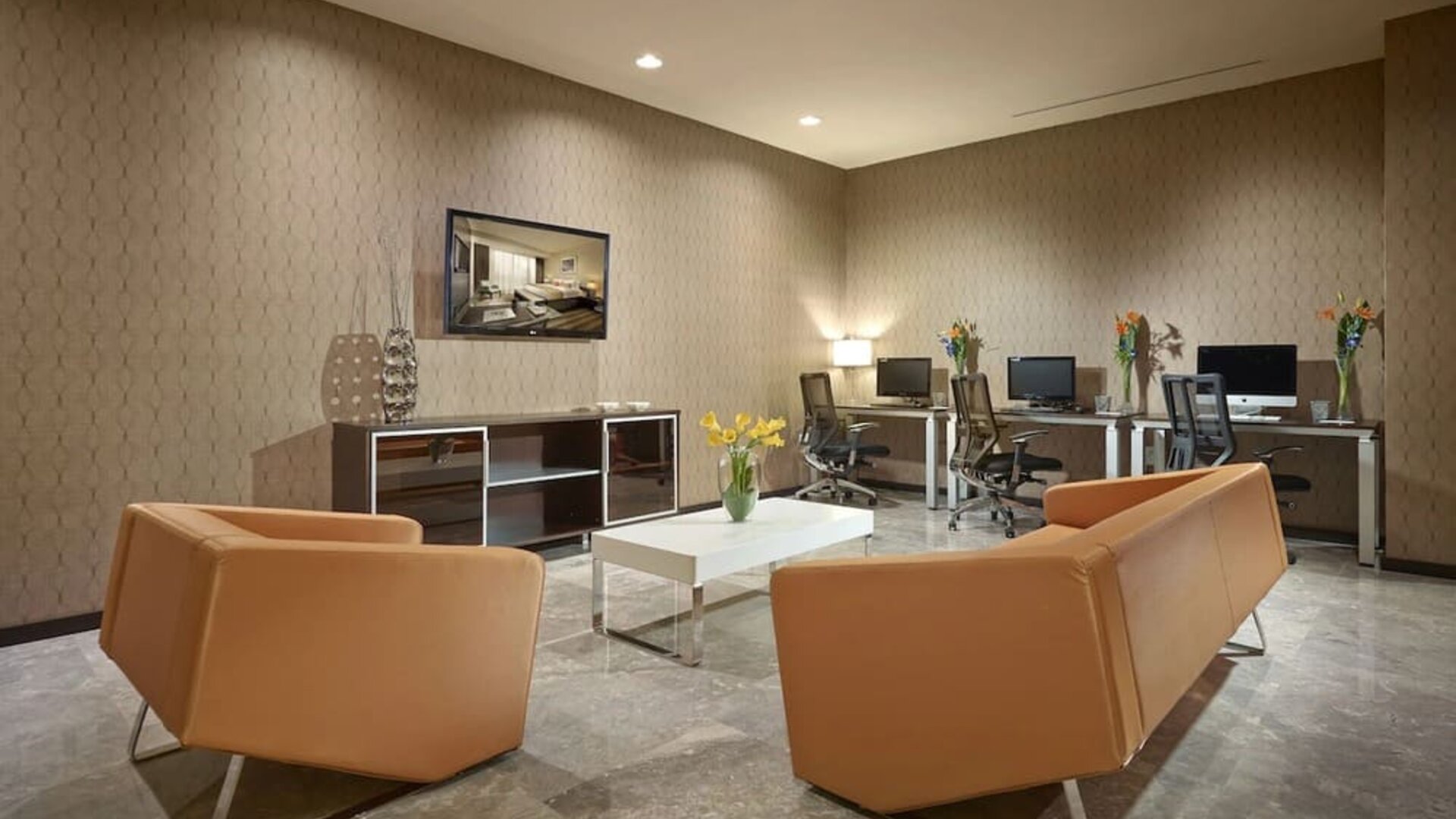 Business center with computers,ergonomic chairs and lounge area at EB Hotel Miami.