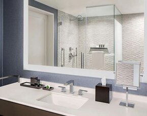 Private guest bathroom with shower and free toiletries at Hyatt Centric Brickell Miami.