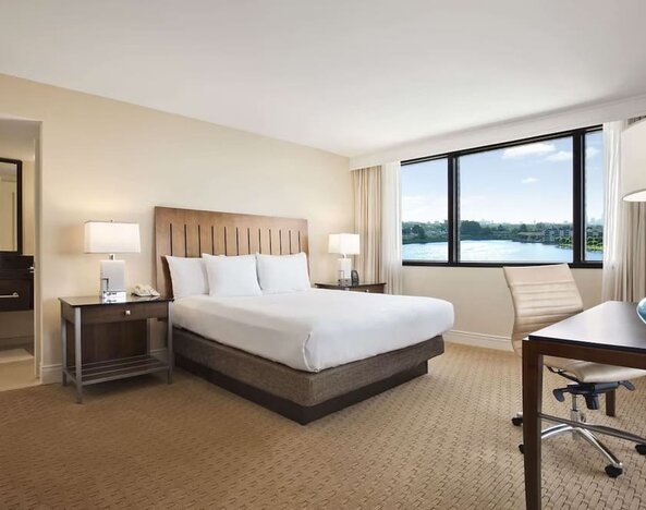 Day use room with large windows, work desk and private bathroom at Hilton Miami Airport Blue Lagoon.