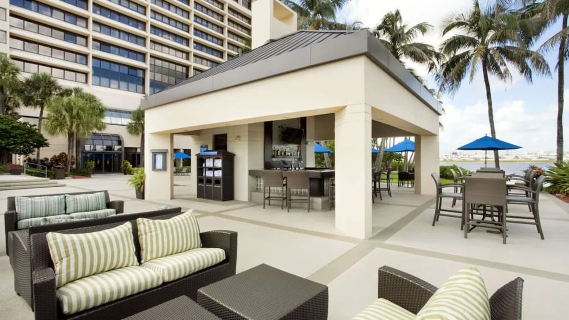Hotel terrace with lounge seating at Hilton Miami Airport Blue Lagoon.