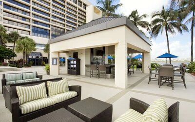 Hotel terrace with lounge seating at Hilton Miami Airport Blue Lagoon.