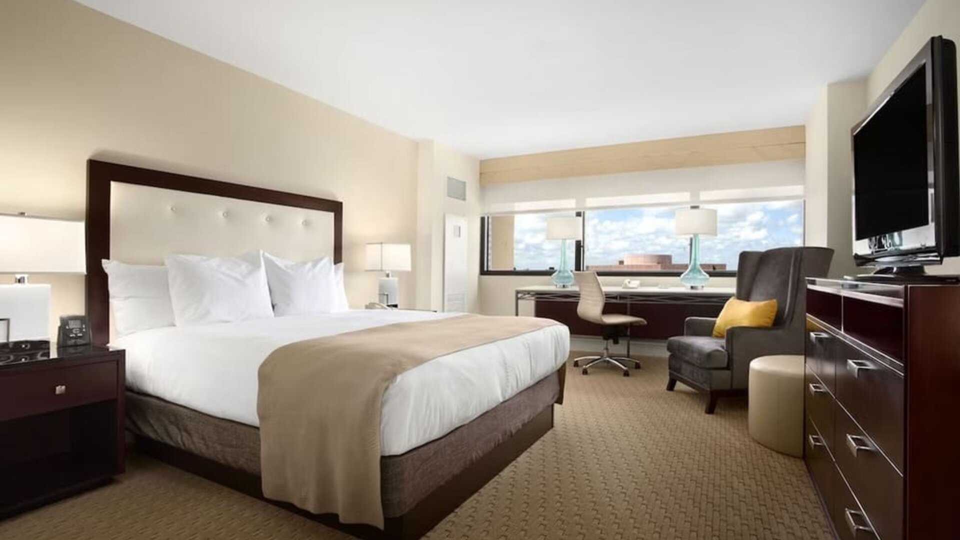 Day use room with work desk, TV screen, private bathroom and large windows at Hilton Miami Airport Blue Lagoon.