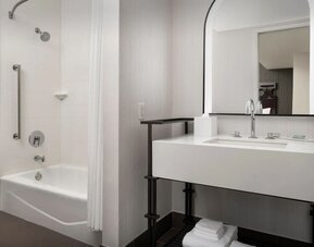 Private guest bathroom with shower and tub at Courtyard San Diego Downtown.