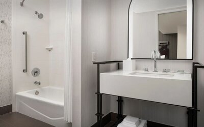 Private guest bathroom with shower and tub at Courtyard San Diego Downtown.