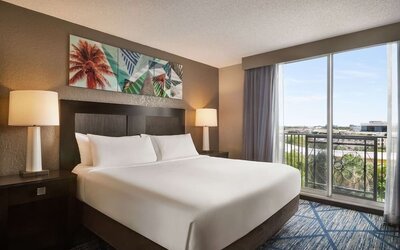 Day use room with large windows, king bed and private bathroom at Embassy Suites By Hilton Miami - International Airport.