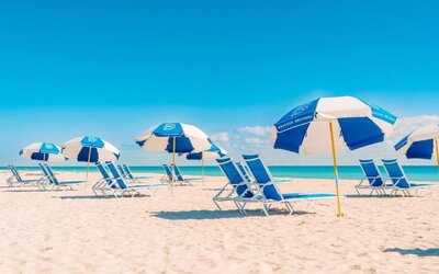 Beach access with lounge seating and umbrellas at The Goodtime Hotel.