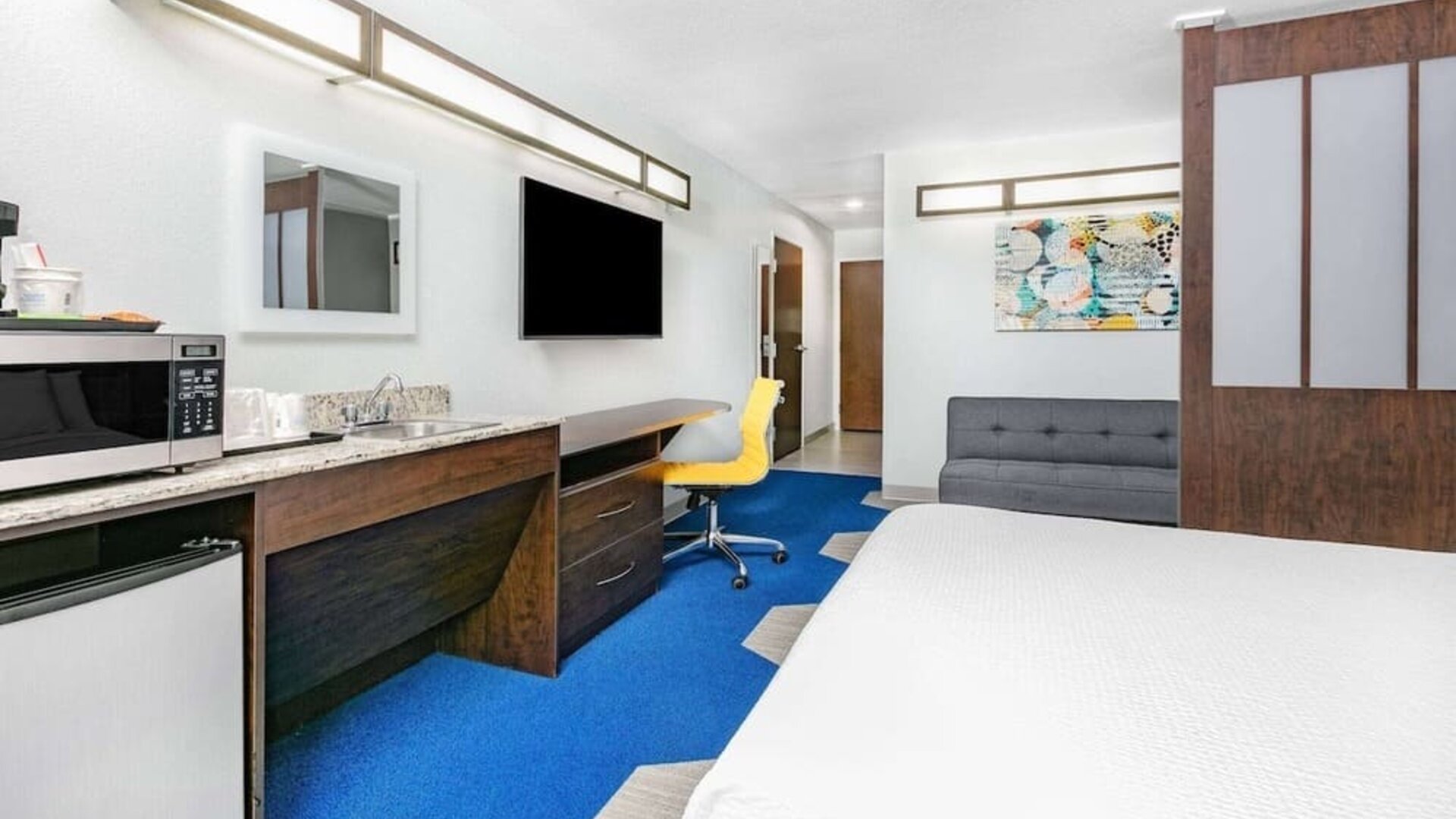 Day use room with TV and work desk at Microtel Inn And Suites By Wyndham Austin Airport.