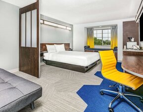 Day use room with TV and work desk at Microtel Inn And Suites By Wyndham Austin Airport.