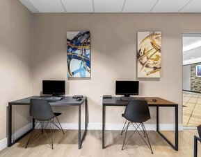 Business center with PC, internet, and printer at Suburban Studios Orlando - Ocoee/Winter Garden.