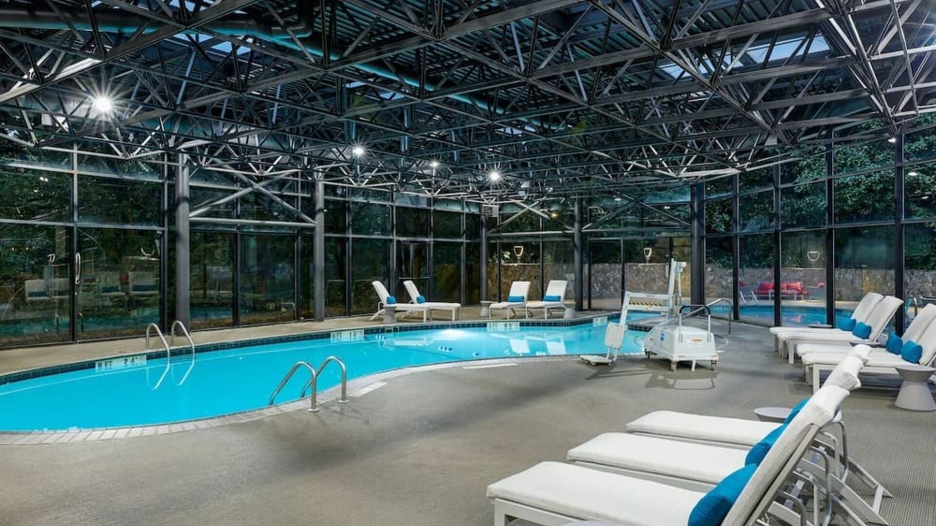 Indoor pool surrounded with loungers at Westin Atlanta Airport Hotel.