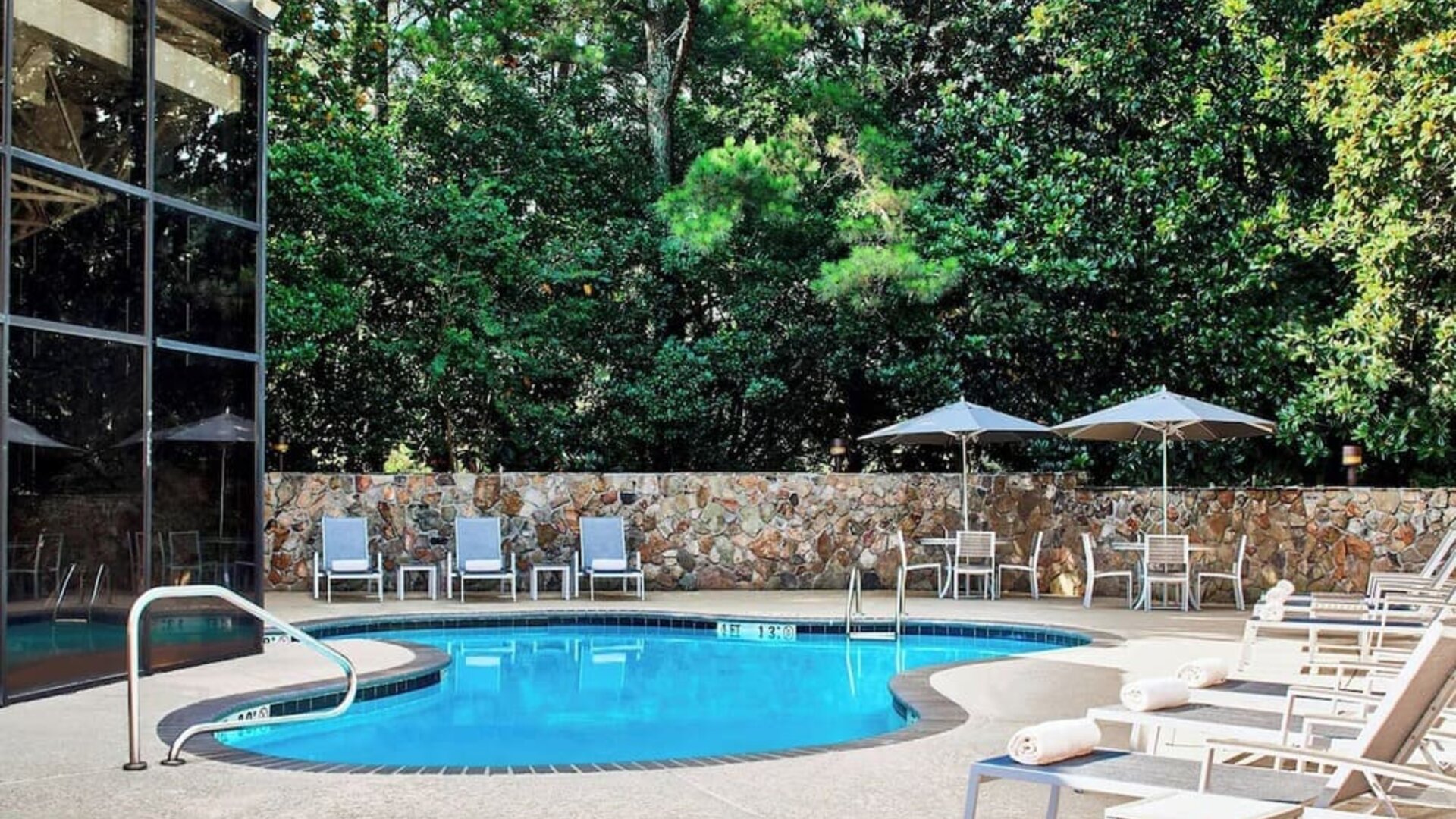 Refreshing outdoor pool surrounded with loungers at Westin Atlanta Airport Hotel.