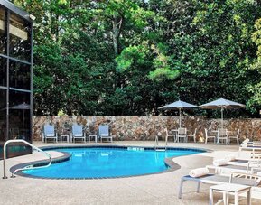 Refreshing outdoor pool surrounded with loungers at Westin Atlanta Airport Hotel.