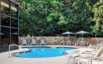 Refreshing outdoor pool surrounded with loungers at Westin Atlanta Airport Hotel.