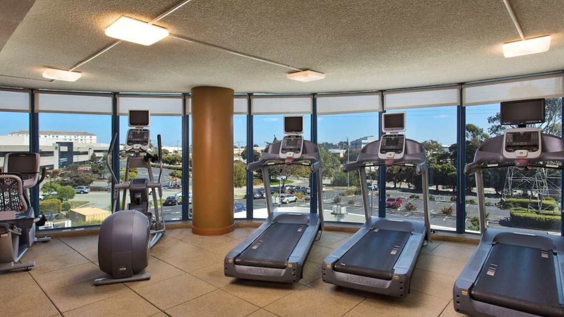 Fitness center with a view at Embassy Suites by Hilton San Francisco Airport.