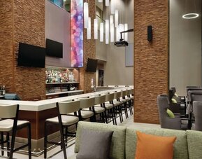 Hotel bar with ample seats at Hilton Garden Inn Calgary Downtown.