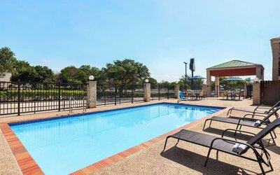 Outdoor pool at Days Inn By Wyndham San Antonio Near Fiesta Park.
