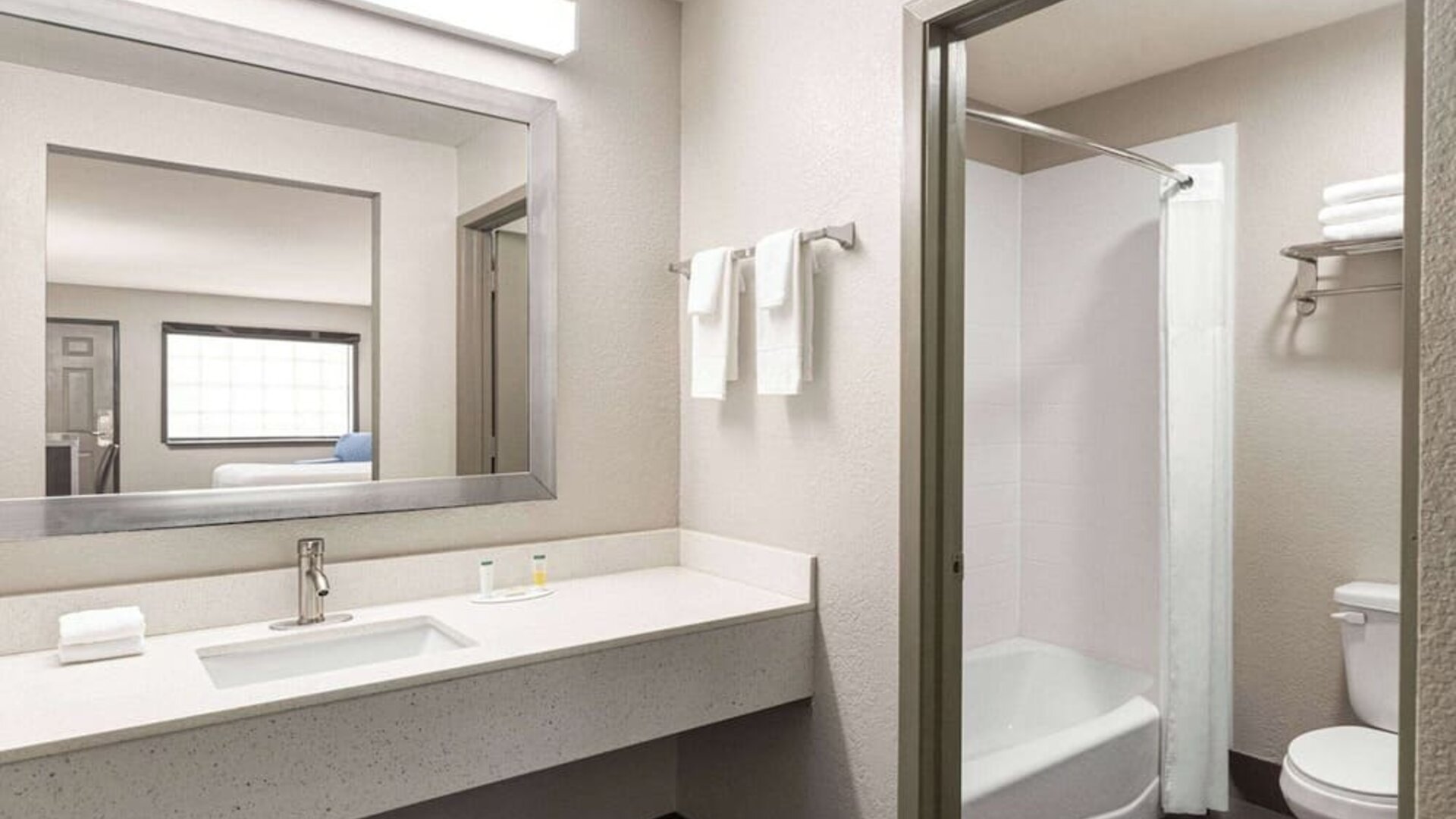 Guest bathroom at Days Inn By Wyndham San Antonio Near Fiesta Park.